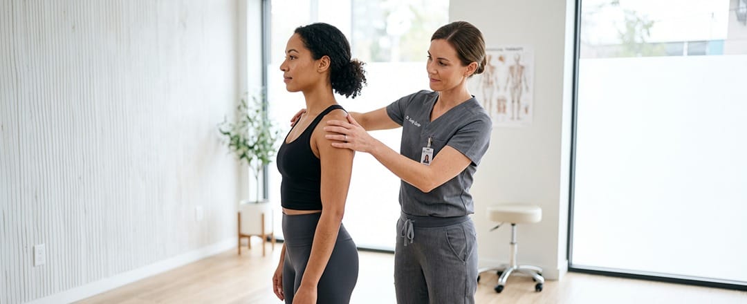 Physical therapist assessing patient strength, mobility and movement